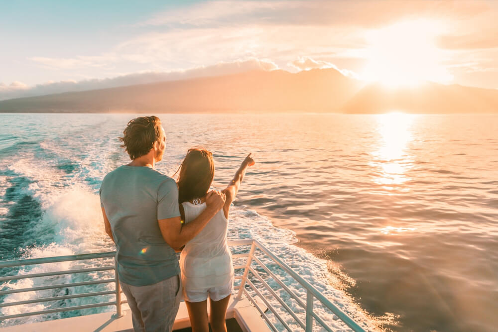 A couple on a sunset cruise during their North Carolina honeymoon on Bald Head Island.